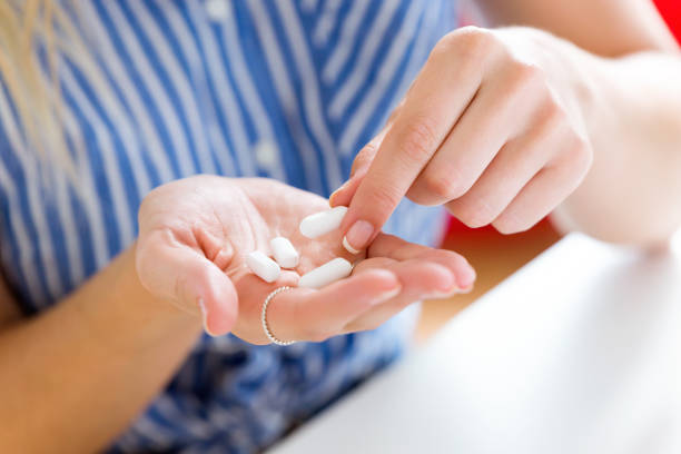 istock Young woman taking in pill. 822449850