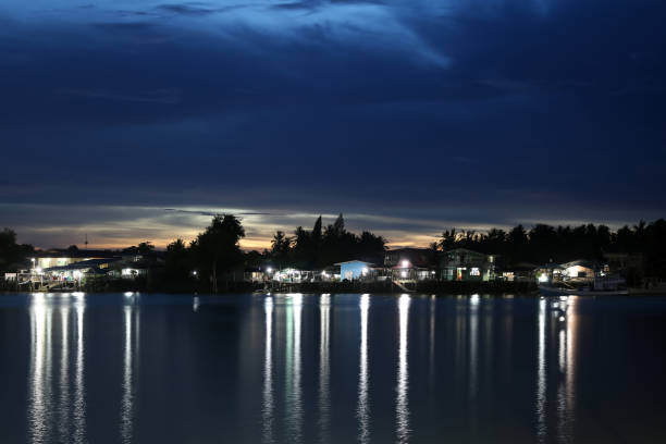 istock Riverside village with lights at night 822449976