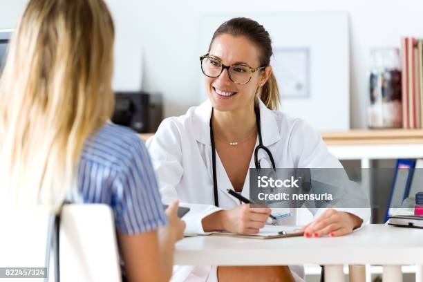 Female Doctor Explaining Diagnosis To Her Patient Stock Photo - Download Image Now - Doctor, Patient, Healthcare And Medicine