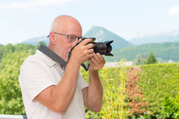 istock mature man with dslr camera, outdoors 822468126
