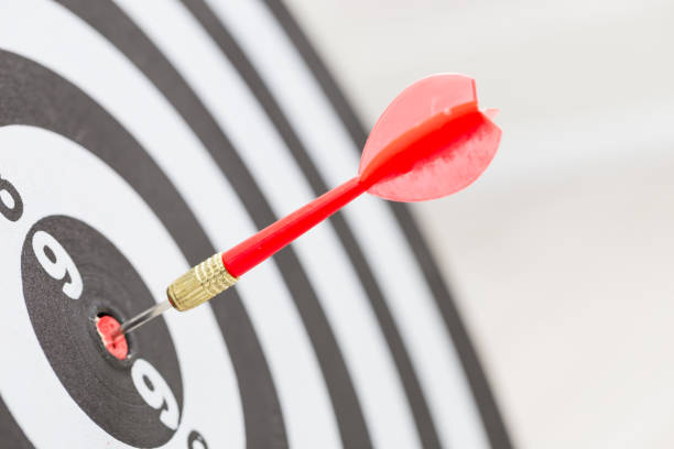 istock Target dart arrow hitting in the center of dartboard 822472564