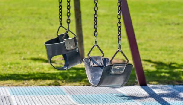 istock Two children's swing seats shallow depth of field 822495962