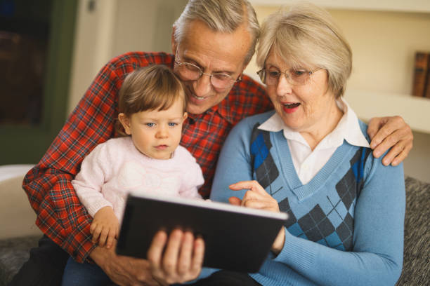 istock Grandparents and grandchild using digital tablet at home 822508130