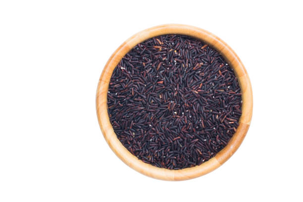 istock rice in wooden bowl on white background., 822509672