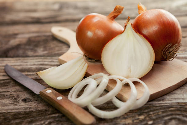 istock Cut fresh bulb of onion on cutting board 822518734