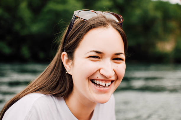 istock Smiling girl sitting next to the water 822519958