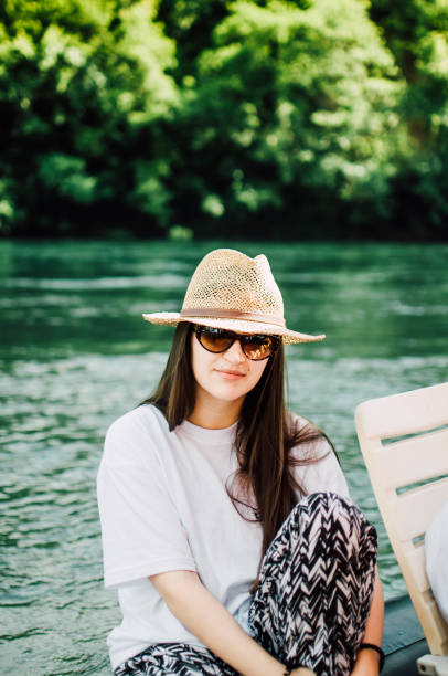 istock The woman is sitting by the river 822520054