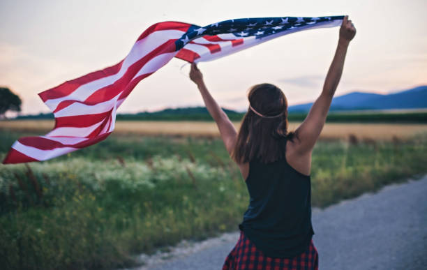 istock Hipster Woman Waving with USA Flag 822520714
