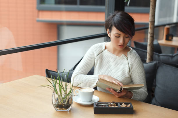 istock Thoughtful woman reading in cafe 822523800