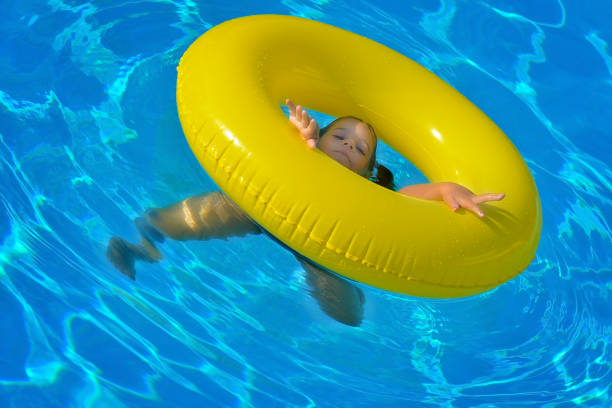 istock Adorable toddler relaxing in swimming pool 822526138