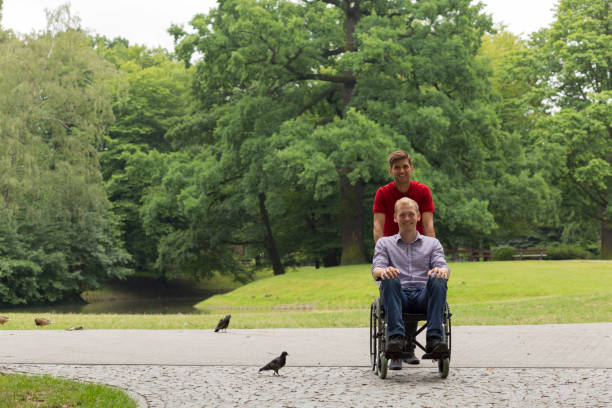 istock Disabled man during a stroll in the park with friend 822526770