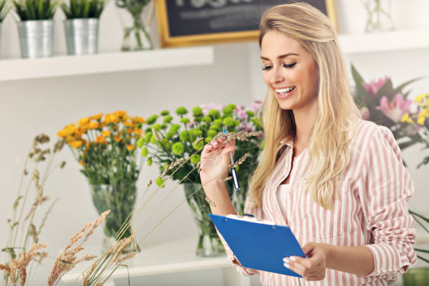 istock Female florist working in flower shop 822531480