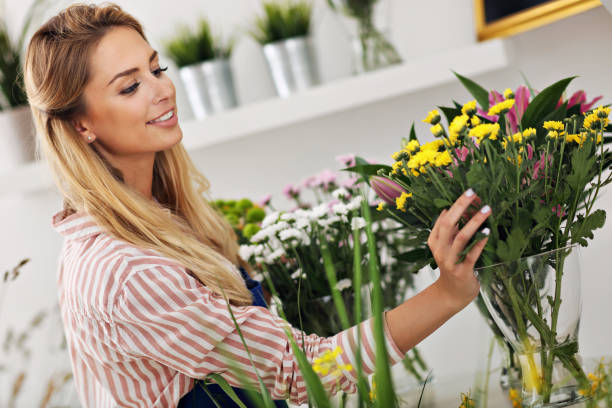 istock Female florist working in flower shop 822532532