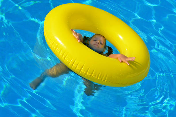 istock Adorable toddler relaxing in swimming pool 822534892