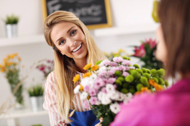 istock Female florist working in flower shop 822540406