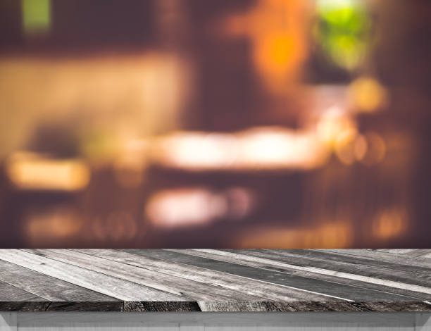 istock Empty grunge diagonal wooden table and blurred restaurant bokeh light background. Mock up for display or montage of product,Business presentation 822555118