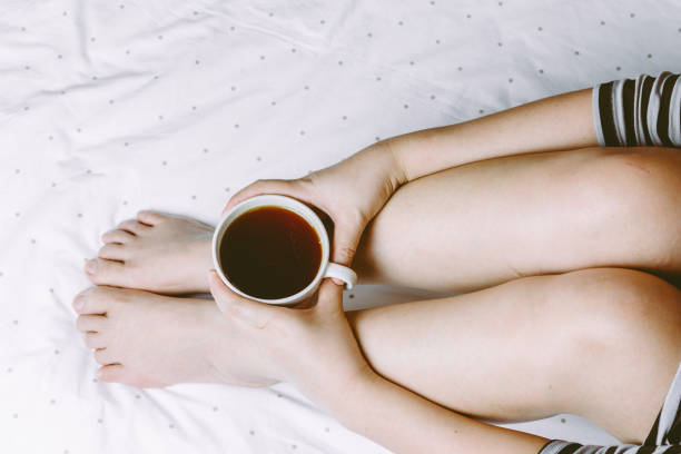 istock Woman on the bed with cup of coffee 822558178