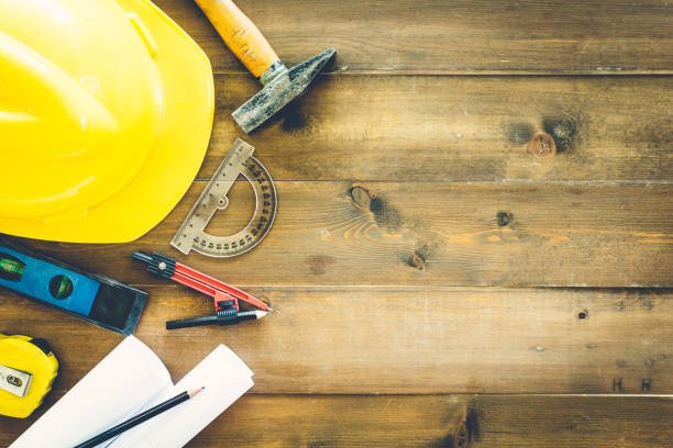 istock Construction tools  with helmet safety on wooden background 822563932