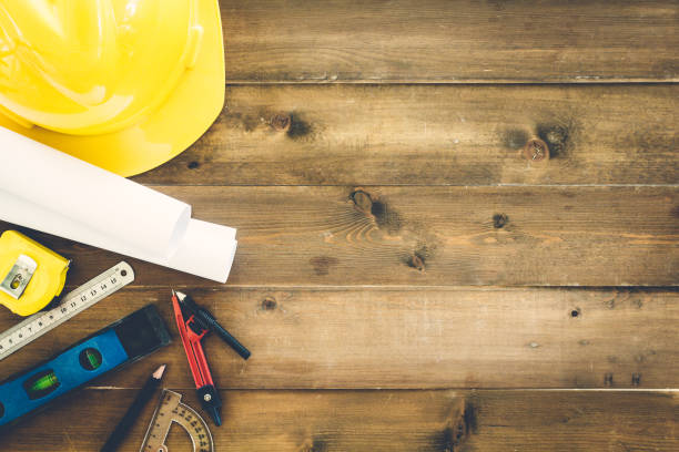 istock Construction tools  with helmet safety on wooden background 822563954