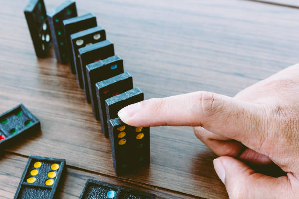 istock Hands playing domino on wooden table 822564370