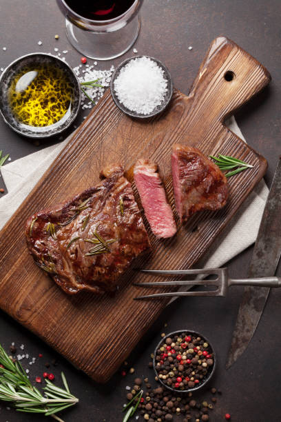 istock Grilled ribeye beef steak with red wine, herbs and spices 822571602