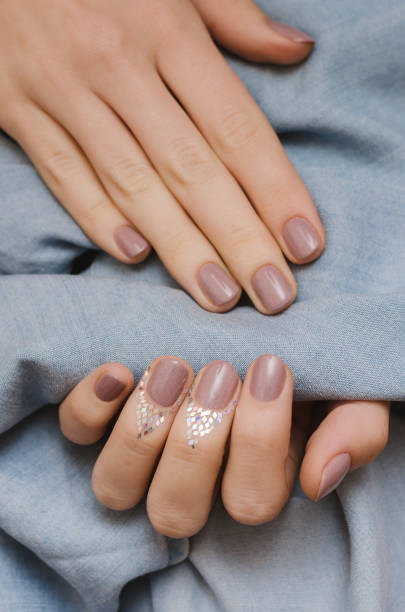 istock Beautiful female hand with pink nail design 822571942