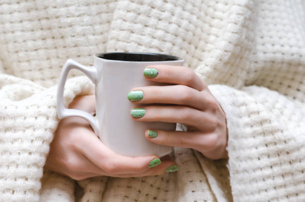 istock Female hands with glitter green nail design. 822572868