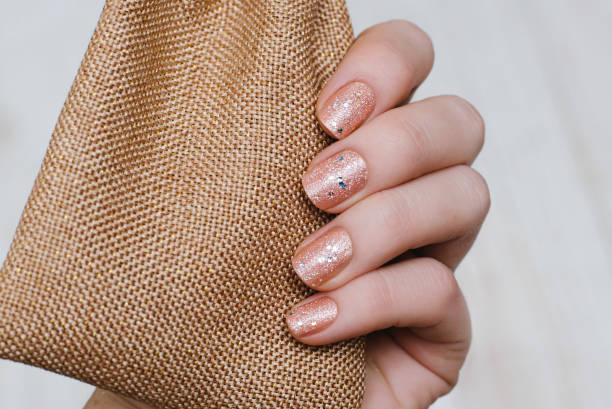 istock Beautiful female hand with dark pink nail design 822573750