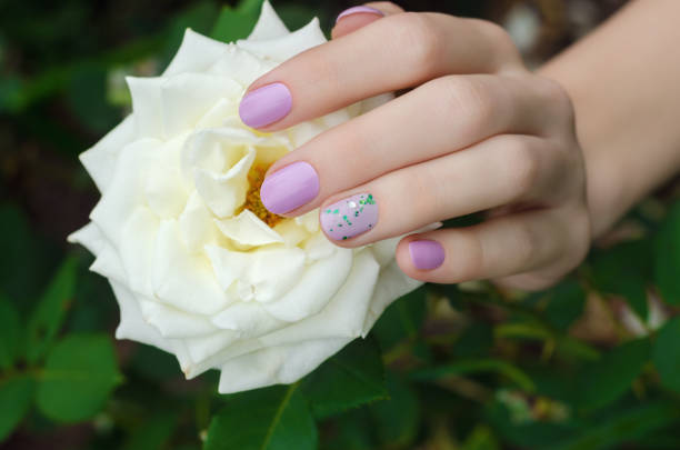 istock Female hands with lilac nail design. 822573924