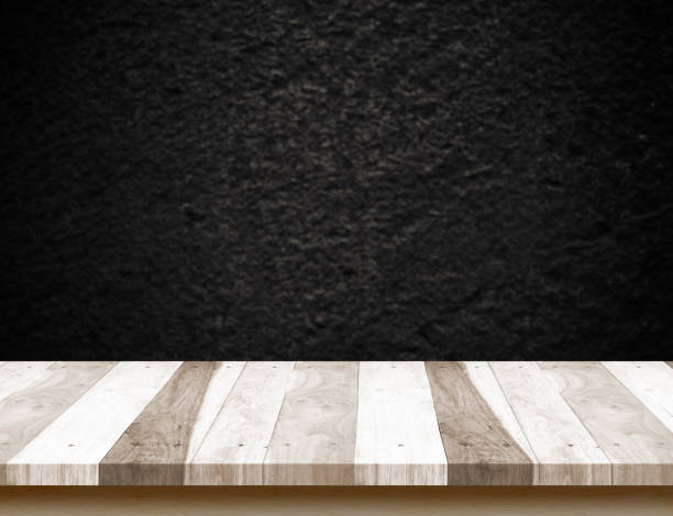 istock Pale Wood plank table top with blur black stone wall,Mock up template for display or montage of product 822574106