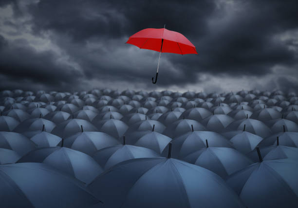 istock Being different concept with red umbrella outstanding from the others 822574130