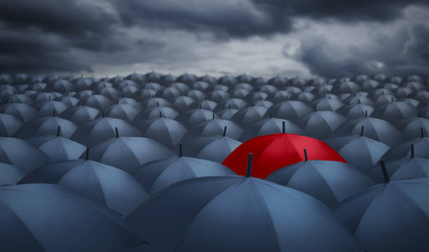 istock Being different concept with red umbrella outstanding from the others 822574156