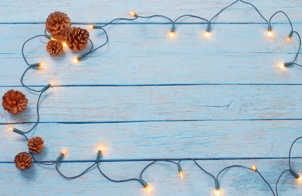 istock christmas lights on blue wooden background 822576646