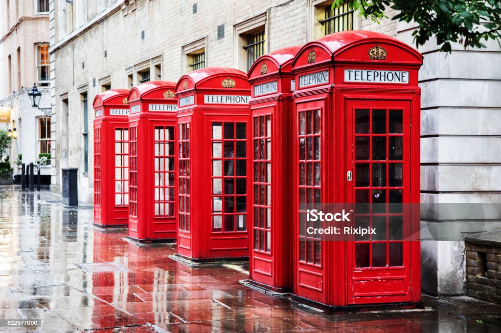 Covent Garden phone boxes Five British red phone boxes in a row. A line of phone booths in Covent garden after the rain. London - England Stock Photo
