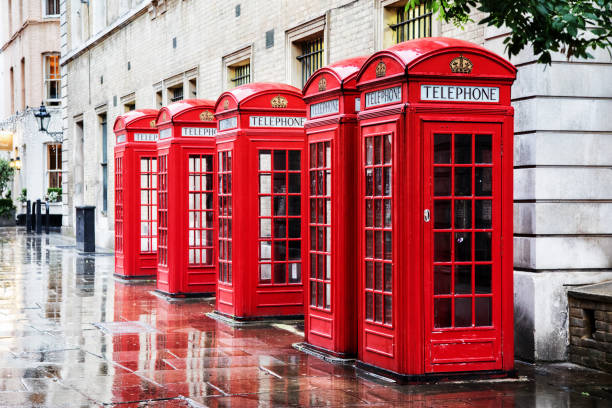 Covent Garden phone boxes Five British red phone boxes in a row. A line of phone booths in Covent garden after the rain. covent garden photos stock pictures, royalty-free photos & images