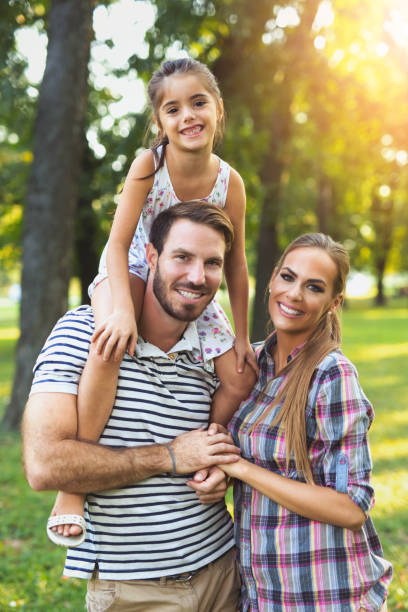 istock Young loving family having fun in the park. 822585084