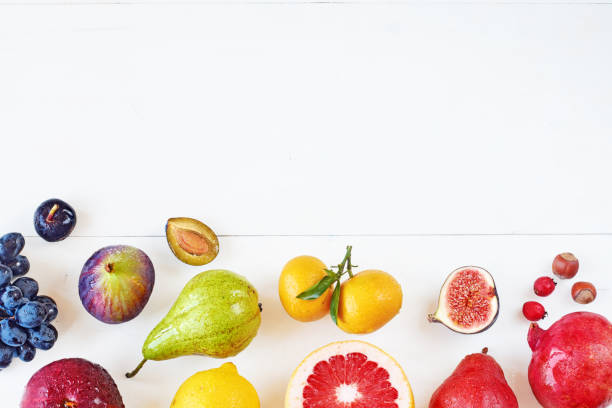 istock Top view of rainbow colored fruits over white background with copy space. 822593904
