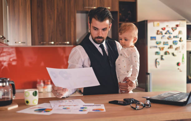 istock Single father working with his baby boy 822594432