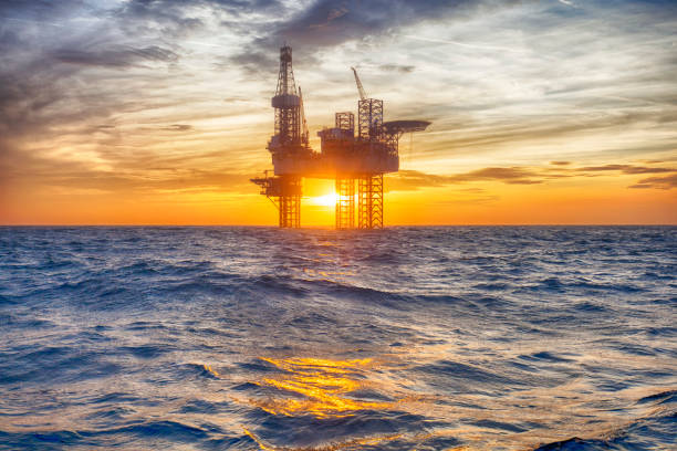 Offshore oil platform at sunset stock photo