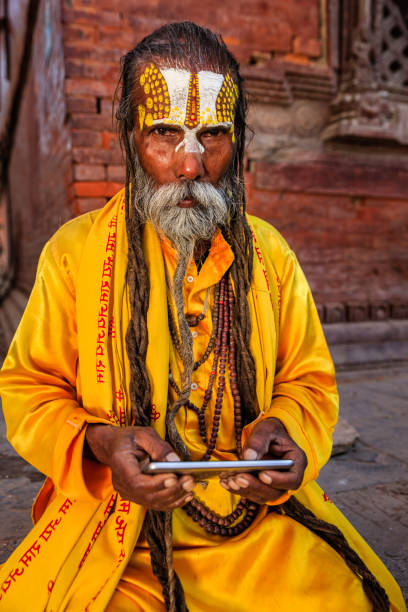 istock Sadhu - indian holyman using mobile phone 822602416