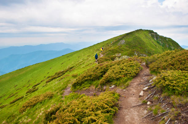 istock Travelers ascending up a winding brown path 822621402