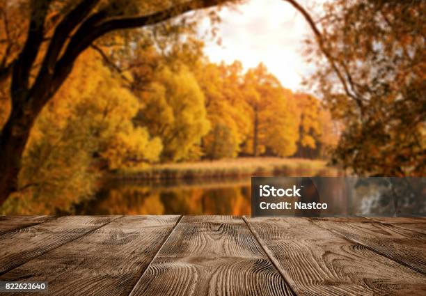 Empty Wooden Table Over The Autumn Landscape Stock Photo - Download Image Now - Autumn, Table, Backgrounds