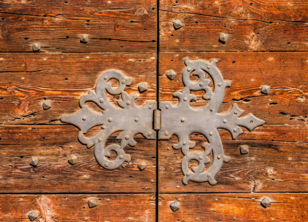 istock Old wooden door with iron hinge 822631410