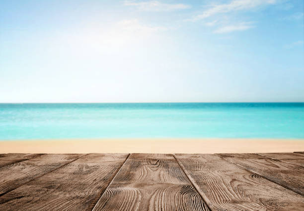 Old empty wooden pier over the turquoise ocean Summer background, close up of old empty wooden pier over the turquoise ocean with copy space floating dock stock pictures, royalty-free photos & images