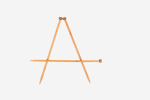 istock Alphabet letter A is arranged from knitting needles. Top view. Isolated on white background 822635696