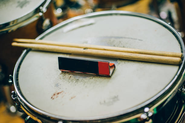 istock Closeup of drumsticks and rolling paper lying on drum set 822672492