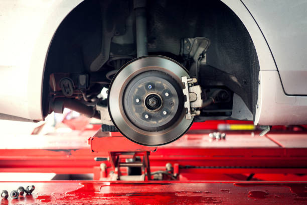 car brake part at garge, car brake disc without wheels closeup - travão imagens e fotografias de stock