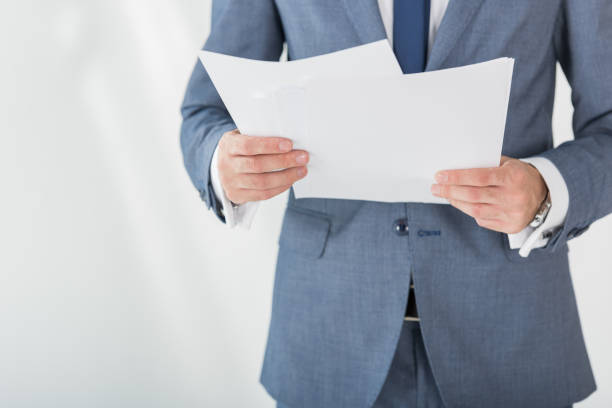 istock partial view of businessman holding papers in hands in office 822686732