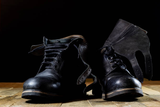 istock Old black Polish military boots on a wooden table. 822687022