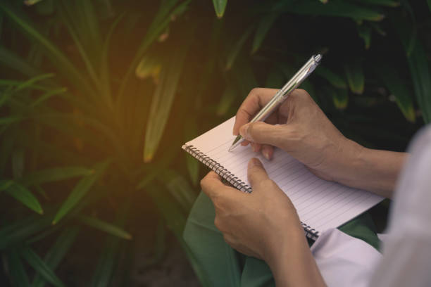 istock Woman sitting and holding a blue pencil and doing an exam 822692814